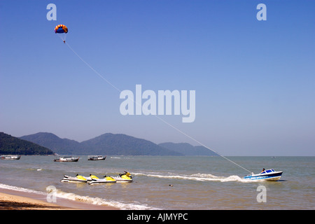 Parasailing and jet skis at Batu Ferringhi beach, Benang Island, Malaysia Stock Photo