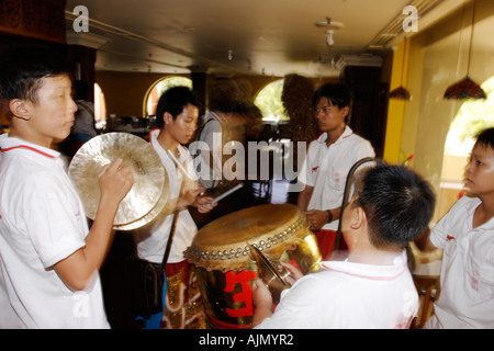 Chinese Malaysians play for the Southern Lion Dance on new years day. Batu Ferringhi, Penang Island, Malaysia. Stock Photo