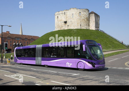 The new First bus 'ftr' street car travelling past Cliffords Tower in York city centre. Stock Photo