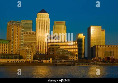 canary wharf shot from across the river thames night evening illuminated office blocks london england uk europe Stock Photo