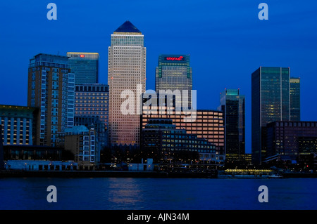 canary wharf shot from across the river thames night evening illuminated office blocks london england uk europe Stock Photo