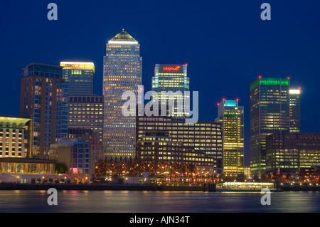 canary wharf shot from across the river thames night evening illuminated office blocks london england uk europe Stock Photo