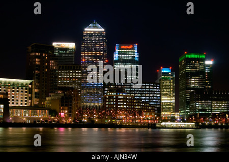 canary wharf shot from across the river thames night evening illuminated office blocks london england uk europe Stock Photo