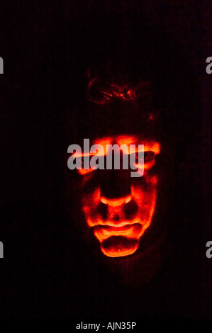 middle aged man lit by torch spooky halloween ghostly effect at night Stock Photo
