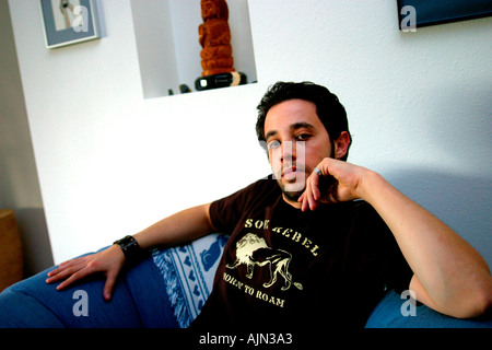 YOUNG MAN RELAXING AT HOME Stock Photo