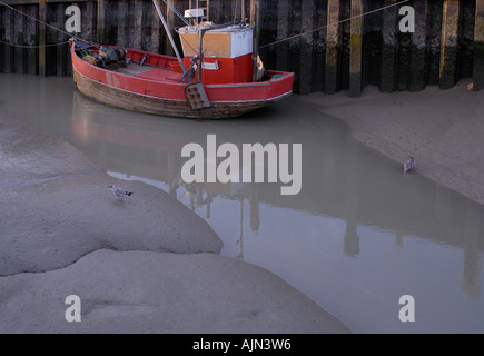 Red old fashioned traditional clinker built timber fishing boat Stock Photo