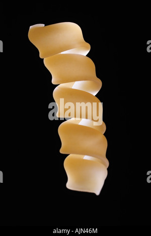 Single noodle on black background Stock Photo