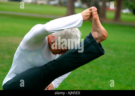 MIDDLE AGED WOMAN DOING YOGA EXERCISE Stock Photo