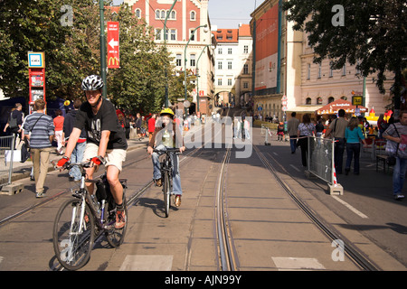 Cyclists riding along a tram lined street, Smetanovo nabr, Prague, Czech Republic, Europe Stock Photo