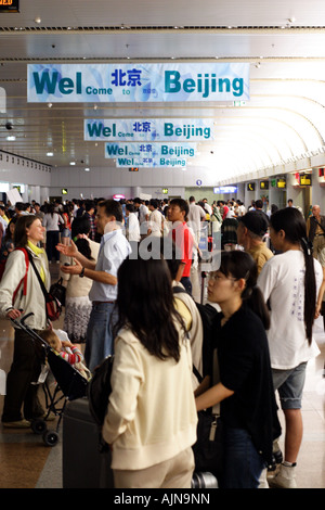 Signs welcome visitors to Beijing in the main causeway of Beijing's International Airport. Stock Photo