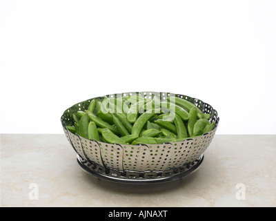 sugarsnaps in steamer Stock Photo