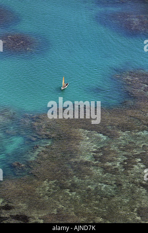 Aerial view of a small sailing boat under maintenance in the blue water ...