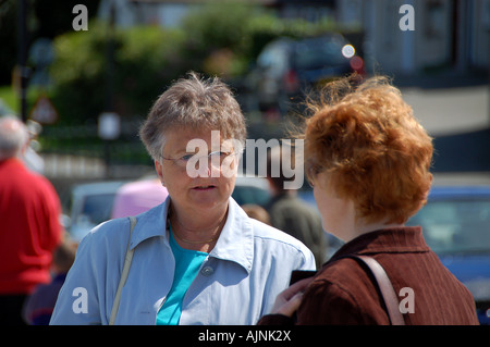 Two women chatting in the street Stock Photo