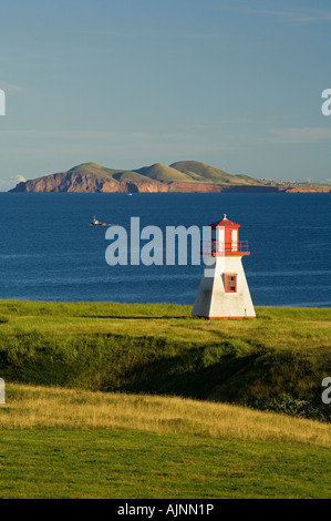 Lighthouse and fishing boat at Cap Alright, Magdalen Islands, Quebec ...