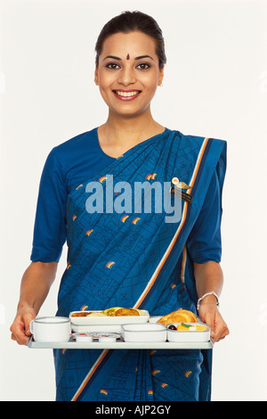 Air hostess holding a tray Stock Photo