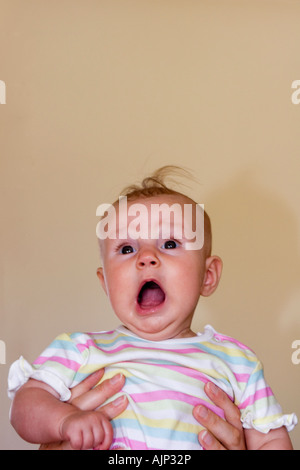 Portrait of baby girl a few months old with a look of surprise Stock Photo