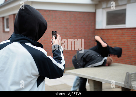 two fighting boys are being recorded by mobile phone Stock Photo