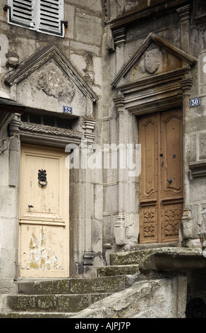 Doorways in Murat old town with triangular frontons with tympanum coat of arms Stock Photo