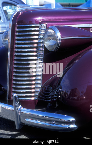 Chrome front grill and headlight detail on a royal purple1938 Buick McLaughlin classic car Stock Photo