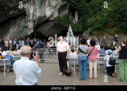 Pilgrims in front of grotto taking pictures of each other