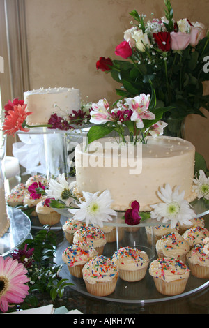 Beautiful wedding cake and treats with flowers Stock Photo