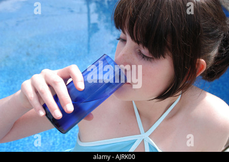 Young woman drinking a glass of water Stock Photo