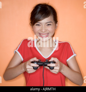 Close-up of a teenage girl operating a joystick Stock Photo