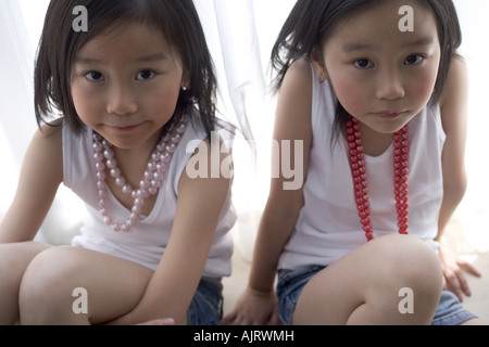 Portrait of two twin sisters wearing beads Stock Photo
