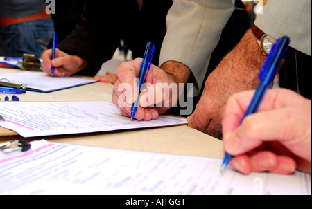 Members of the public signing a petition against cuts in mental health services, Kingston, Surrey, UK. Stock Photo