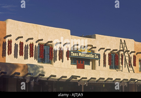 Adobe building decorated with chili pepper ristras at Plaza in Taos, New Mexico, USA Stock Photo