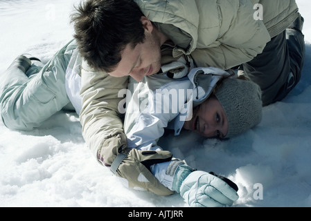 Young friends playfighting in snow Stock Photo