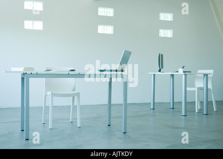 Computers on desks in office Stock Photo