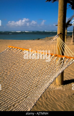 white rope hammock on tropical beach, Island of Nevis, St Kitts and Nevis Caribbean island,   Pinney's Beach, Nevis, idyllic tro Stock Photo