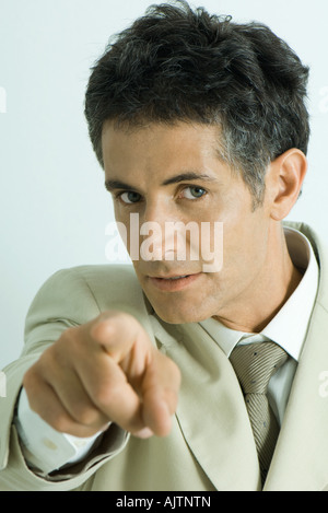 Businessman pointing at camera, portrait Stock Photo