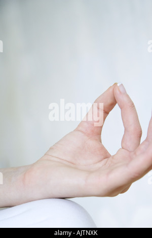 Woman in lotus position, cropped view of hand Stock Photo