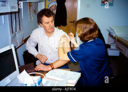Man Having Injection In Arm Stock Photo