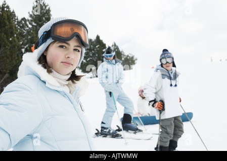 Group of young friends on skis, focus on teen girl in foreground Stock Photo