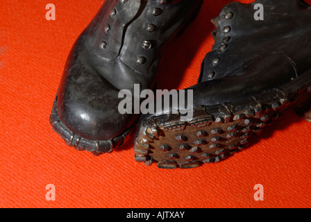 Vintage Swiss military leather hobnail mountain boots featuring distinctive metal studs on the soles for alpine traction. Stock Photo