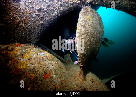 A diver investigates the propeller of The Salem, a shipwreck on Hyndman Reef in the Gulf Of Tadjoura near Djibouti. Stock Photo