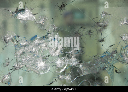 Israeli soldier seen through cracked reinforced glass which was hit by bullets in a barrier separating Palestinian and Israeli control area in Hebron Stock Photo