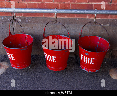 Three fire buckets hanging on a pole. Stock Photo