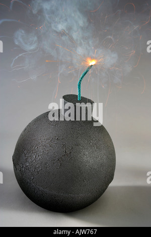 An old fasdhioned style round bomb with a lit fuse about to explode Stock Photo