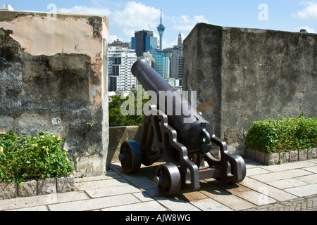 Iron Cannon Fortaleza do Monte Colonial Fort in Macau SAR Macau Tower in background Stock Photo