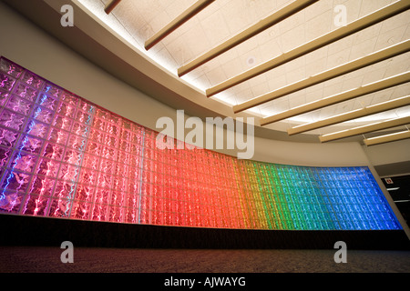 Curved glass block brick wall with colored fluorescent lights at Washington Dulles International Airport IAD Concourse C-D. VA Stock Photo