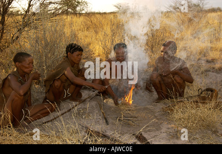 San Family Making Fire in the Kalahari Stock Photo