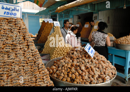 Sweet pastries for sale at a street stall down an alleyway in Kairouan Tunisia Stock Photo