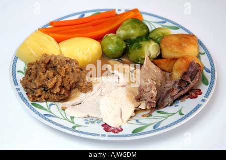 A plate with traditional festive turkey brussels sprouts roast and boiled potatoes carrots and stuffing Stock Photo