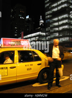 Man exiting taxi in street Stock Photo - Alamy