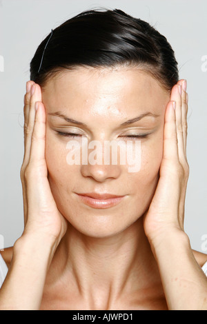 young woman stretching the skin of her face Stock Photo