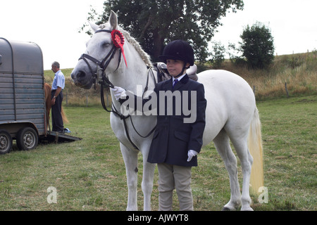 Eriskay Pony and Rider at a Show with a Red Rosette Stock Photo
